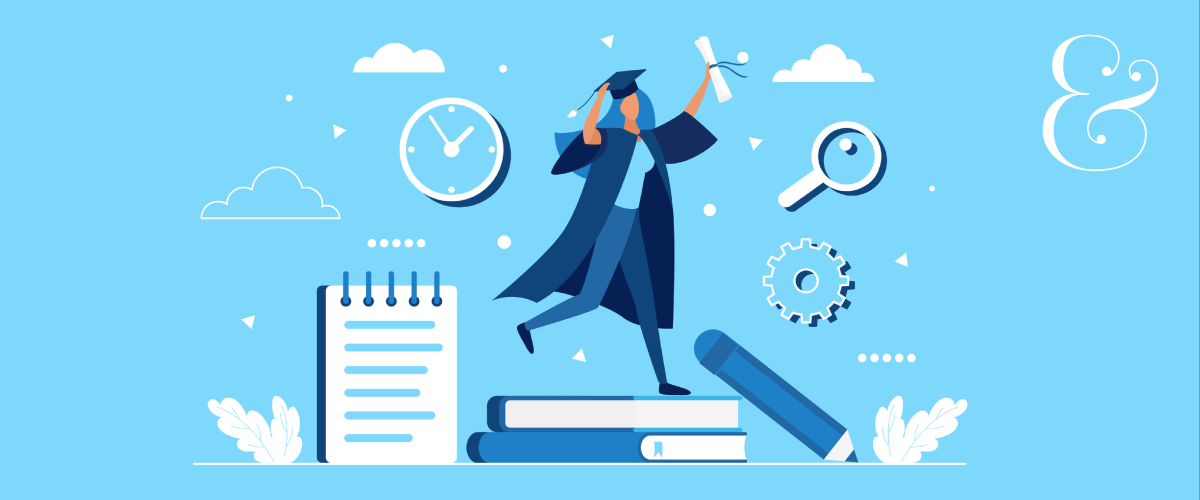 Female graduate stands on life-sized pile of books next to a notepad, pencil and other supplies.