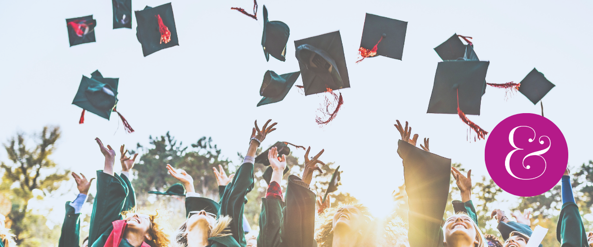 happy graduates tossing caps into the sky