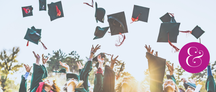 happy graduates tossing caps into the sky